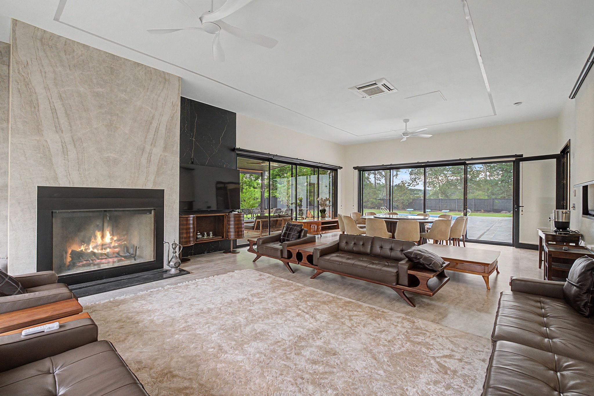 Fireside family room opening to the pool