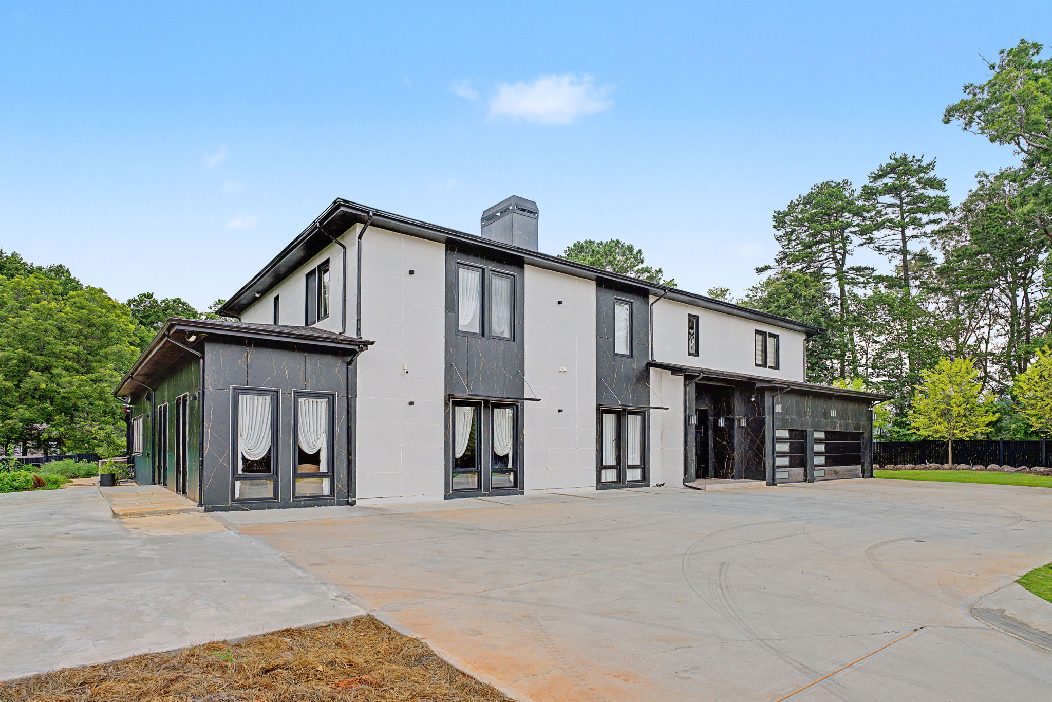 Contemporary black and white exterior of the estate